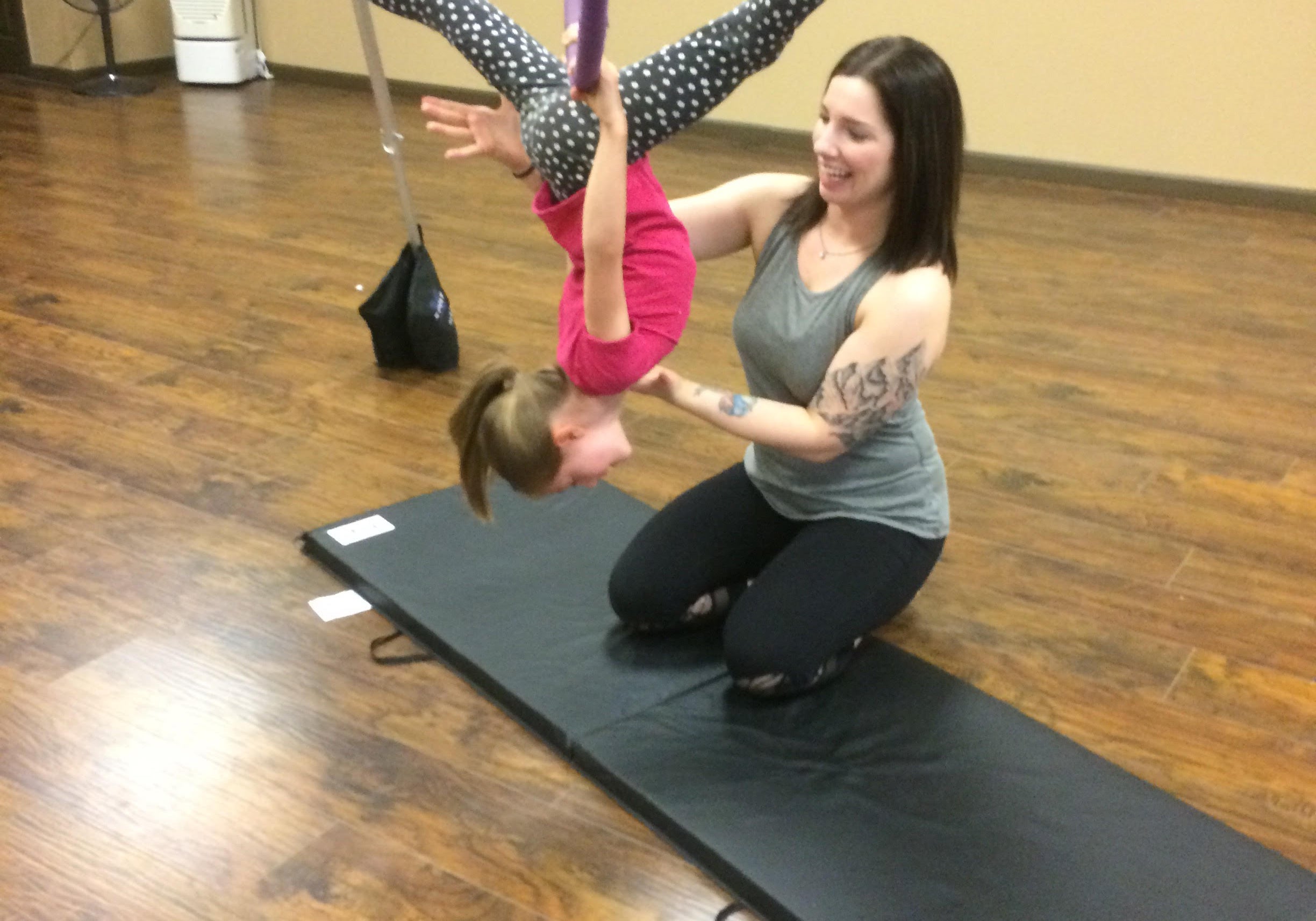 Jessalyn Hoffman teaching a child in Ombre Yoga Hammock