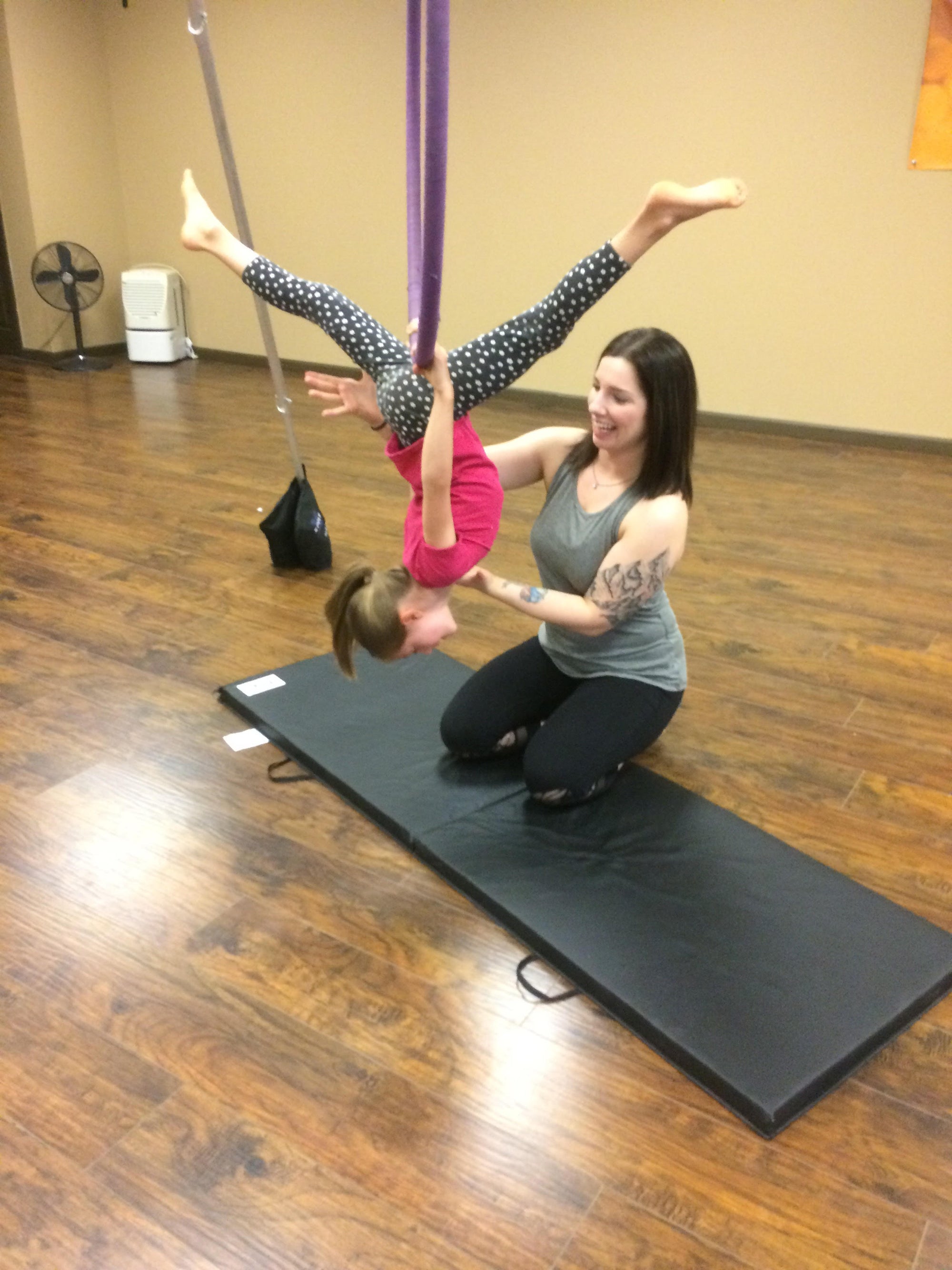 Jessalyn Hoffman teaching a child in Ombre Yoga Hammock