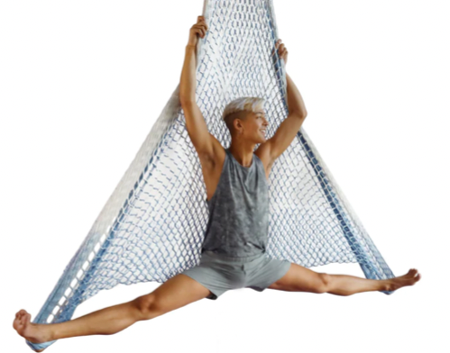 Aerial performer hanging from a blue and white net hammock.