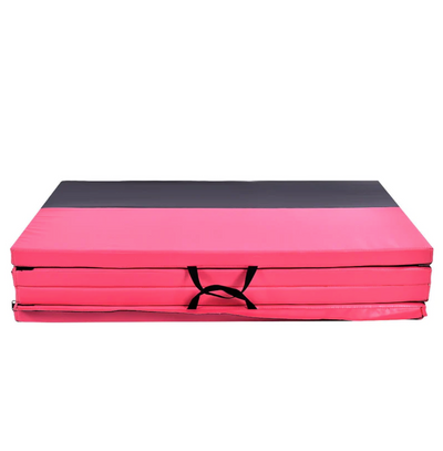 Pink and black folded exercise mat.