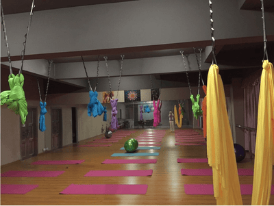 Studio room with multiple yoga hammocks.